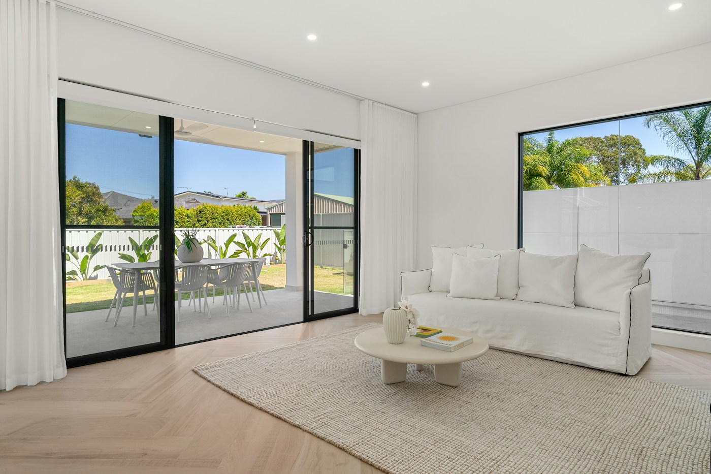 Illustrative photo of a bright living room with large windows